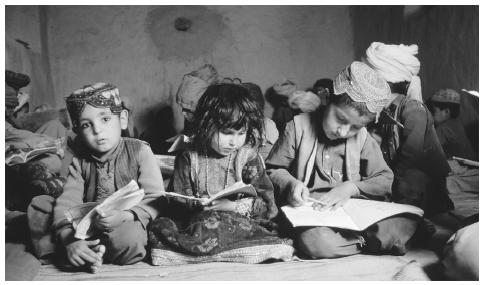 A group of children read in a mosque school in Arghandab,  Afghanistan. Although education is valued in Afghanistan, only 5 percent  of Afghani children receive a primary education.