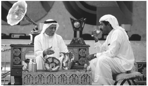 Men partake in the traditional past-time of coffee-drinking in the Gulf Hotel in Manama. The scarf that covers a man's head is called a  gutra.