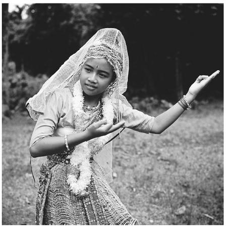 A young Bengali woman performs a traditional Manipuri dance. Almost all traditional dancers are women.