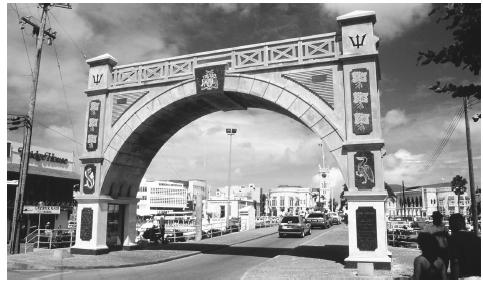 An arch extends over a road in the capital city of Bridgetown. The majority of the population, about 80 percent, live in or near the city.