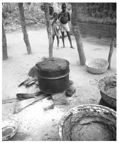 This Benin village cooks food communally in a large pot. Most cooking is done outdoors, even in urban areas.