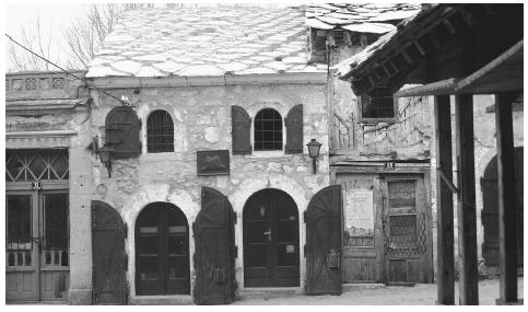 A building with arched double doors in Mostar, the largest city in the Herzegovina region. Mostar was badly damaged by the civil war.