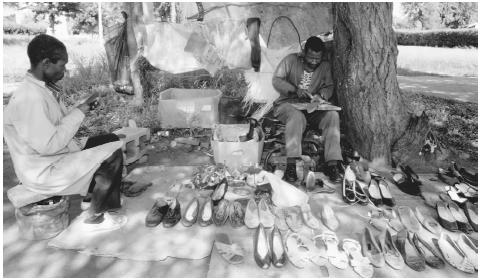 A man repairs shoes in the street in Gaborone, Botswana.