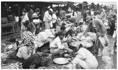 Mingalla Market, Mandalay. Men and women engage equally in small marketplace selling and trading.