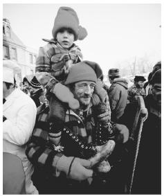 A father and son celebrate their lumber heritage during the winter Lumberjack Parade in Chicoutimi, Quebec.
