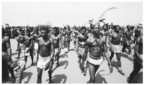 Men march in traditional dress to celebrate the coronation of Emperor Bokassa I.