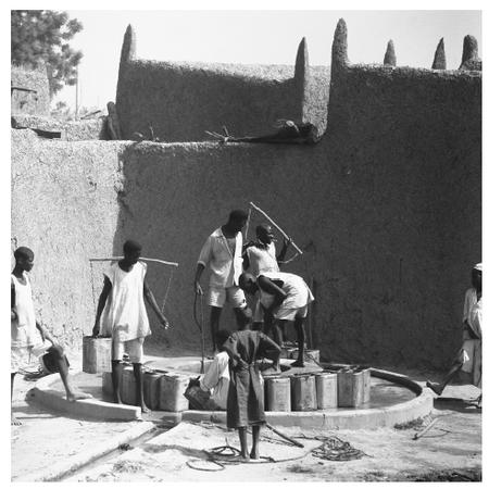 Children and adolescents rarely pursue a complete education in Chad. These young men and boys are helping their households by drawing water from a well.