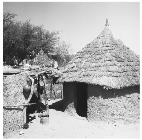 A traditional mud hut stands in the village of Massaguet, but modern, iron-and-concrete buildings are being built more frequently throughout Chad.