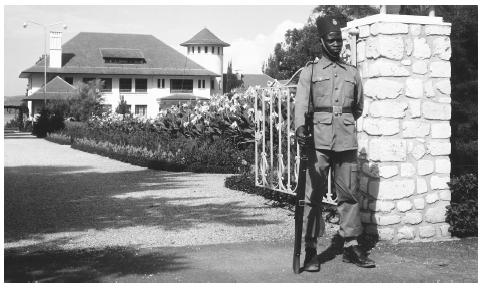 A guard stands at the gate to the palace of the governor of Kivu.
