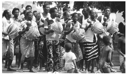 At the funeral of Nanan Toto Kra, a Baoule Akan, Mossi men dance with calabash rattles. Funerals, held 40 days after death, are important and elaborate ceremonies for Ivoirians.