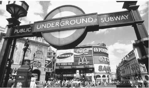 Advertisements and a sign for the Underground in London's busy Piccadilly Circus.