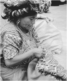 A woman embroidering in Antigua. Handicrafts have been produced and widely traded in Guatemala for centuries.