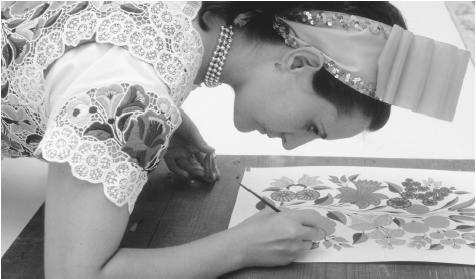 A woman paints a flower design which will be used to make a traditional Hungarian dress in Kalocsa, Hungary.