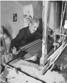 A carpet maker works on a loom at his shop in Na'in.