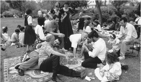 A Sephardic family celebrates the Jewish festival of Passover by sharing a picnic in West Jerusalem.