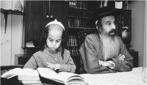 A Torah scribe works with his son. Judaism is the official Israeli religion, and the Torah is the most sacred text.