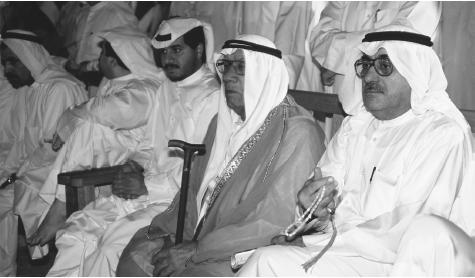 Kuwaiti men in traditional robes attend a meeting in Kuwait.