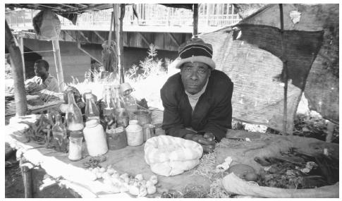 A medicine man selling herbs at a market in Blantyre. Medicine men are sought out to cure illness and to aid in such tasks as finding a wife.