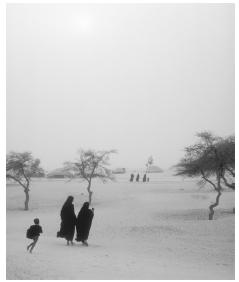 A few Tuareg people outside Timbuktu during a dust storm. Conflicts between the Tuareg and the Malian government improved after the signing of a 1994 peace accord.
