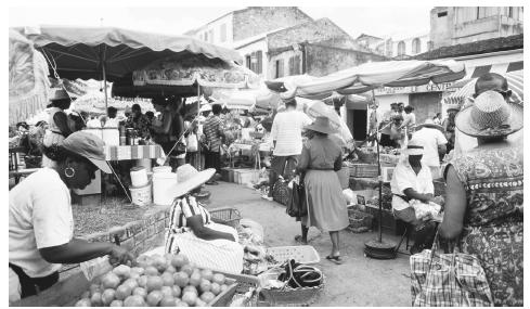 Produce and goods for sale at an open-air market in Saint-Pierre. Traditional meals are a combination of French and Creole cuisines.