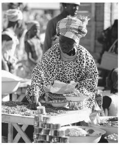 A woman buying peppers at the market in Naimey; there are permanent markets in major towns and market days in rural communities.