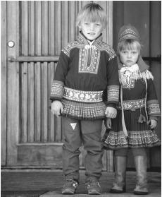 A young Lapland boy and girl wearing traditional dress in Kautokeino. Each large fjord or valley has a distinctive costume.