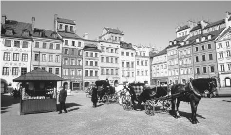 Horse-drawn carriages await passengers in a square in Old Town  Warsaw. Warsaw has been Poland's capital since 1611, when it succeeded  Cracow.