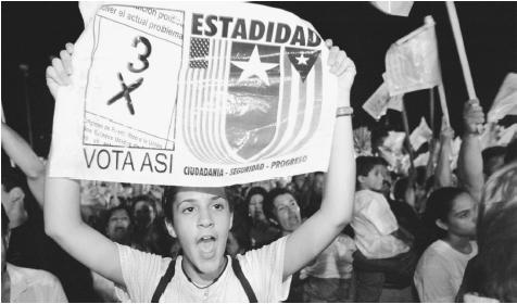A young woman holds a banner during a pro-statehood demonstration. A U.S. commonwealth since 1952, Puerto Rico has maintained a strong sense of nationalism.