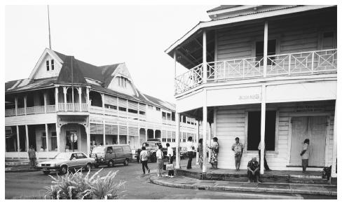 People under the portico of the immigration office as traffic passes by in Apia. Ethnic tensions are virtually non-existent in Samoa.