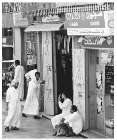 A group of Saudi men gather in front of a store in Jeddah. Men have substantially more rights than women, who must remain out of public view.