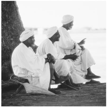 Three men sit by the river in the Ali-Abu region of Sudan. Seventy percent of Sudanese are Sunni Muslim.