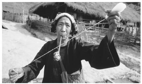 An Akha woman hand spinning wool. Though women have made many advancements in Thailand, they are concentrated in lower-paying jobs.