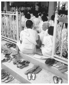 Footwear is removed when attending a ceremony near the Mae Nam Noi River, Thailand.