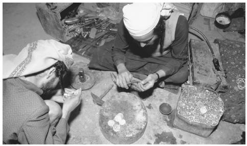 Two Jewish jewelers at work in north Sana'a. Goods produced by small vendors are an important part of market-based commercial activity.