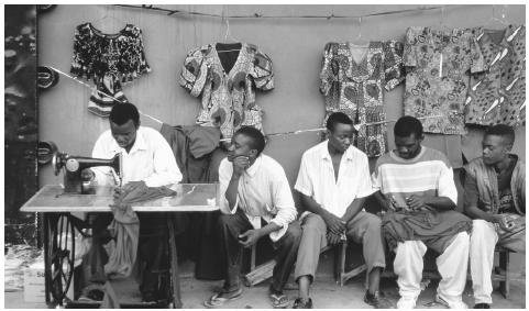 A tailor's stall market in Lusaka, Zambia. The stall is not only the tailor's business, but it is also a place to socialize.