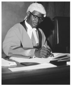 A Zambian judge overseeing a judicial tribunal in the attire of the British colonial legal tradition, Zambia.