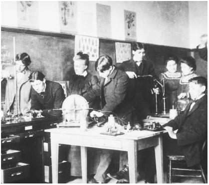 These Apache boys and girls are conducting physics experiments at the Carlisle Indian School in Pennsylvania, c. 1915.