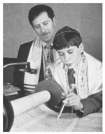 This boy reads from the Torah during his Bar Mitzvah.