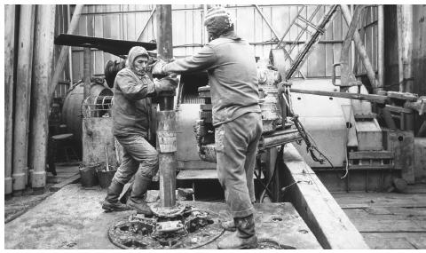 Workers on an offshore drill in the Caspian Sea dismantle a drilling pipe.