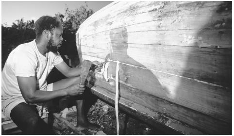 A shipwright is building a boat on Carrot Bay on the island of Tortola. Fishing was historically one of a man's household responsibilities.