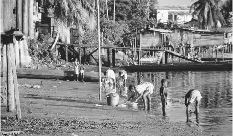 Children washing clothes in a river in Saint Laurent. More than twenty rivers find their way to the Atlantic Ocean from French Guiana.