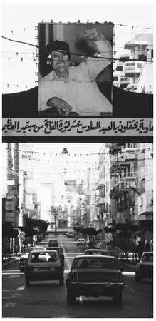 A Muammar Qaddafi banner hangs over a street in Tripoli. Qaddafi assumed leadership of Libya in 1969.