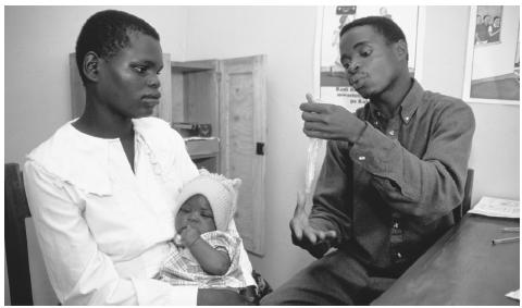 A woman and child visit a family planning clinic in Malawi. The average woman will bear five to six children, but fewer than half survive beyond five years of age.