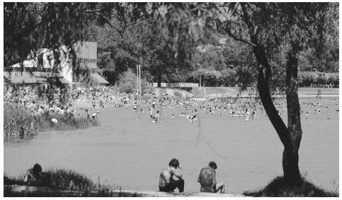 Swimmers and sunbathers at a lake in Chisinau. The central portion of the country enjoys long, warm summers.