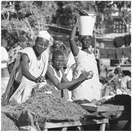 Nigerian people at a market. Food plays a central role in the rituals of all ethnic groups in Nigeria.