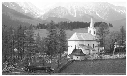 Mountains and trees surround a small white church and graveyard. Slovakia has extremely varied topography for its size; its elevation ranges from 308 feet (94 meters) to 8,722 feet (2,655 meters).