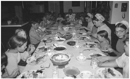These Amish families are gathered together to eat a traditional meal.