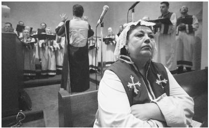 Maro Partamian, a mezzo soprano, waits to rejoin her choir during the christmas liturgy at the St. Vartan Armenian Cathedral in  New York.