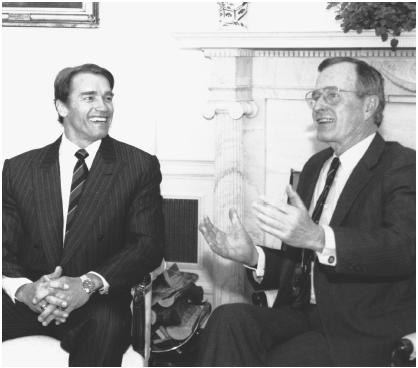 Austrian American Arnold Schwarzenegger, in his role as president of the President's Council on Physical Fitness and Sports, meets with President George Bush at the White House in January 1990.