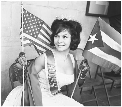 At the 45th Anniversary of the U.S. granting citizenship to Puerto Rico in New York, Gladys Gomez of the Bronx gets to represent her home country of Bolivia. She is holding a U.S. and a Puerto Rican flag.